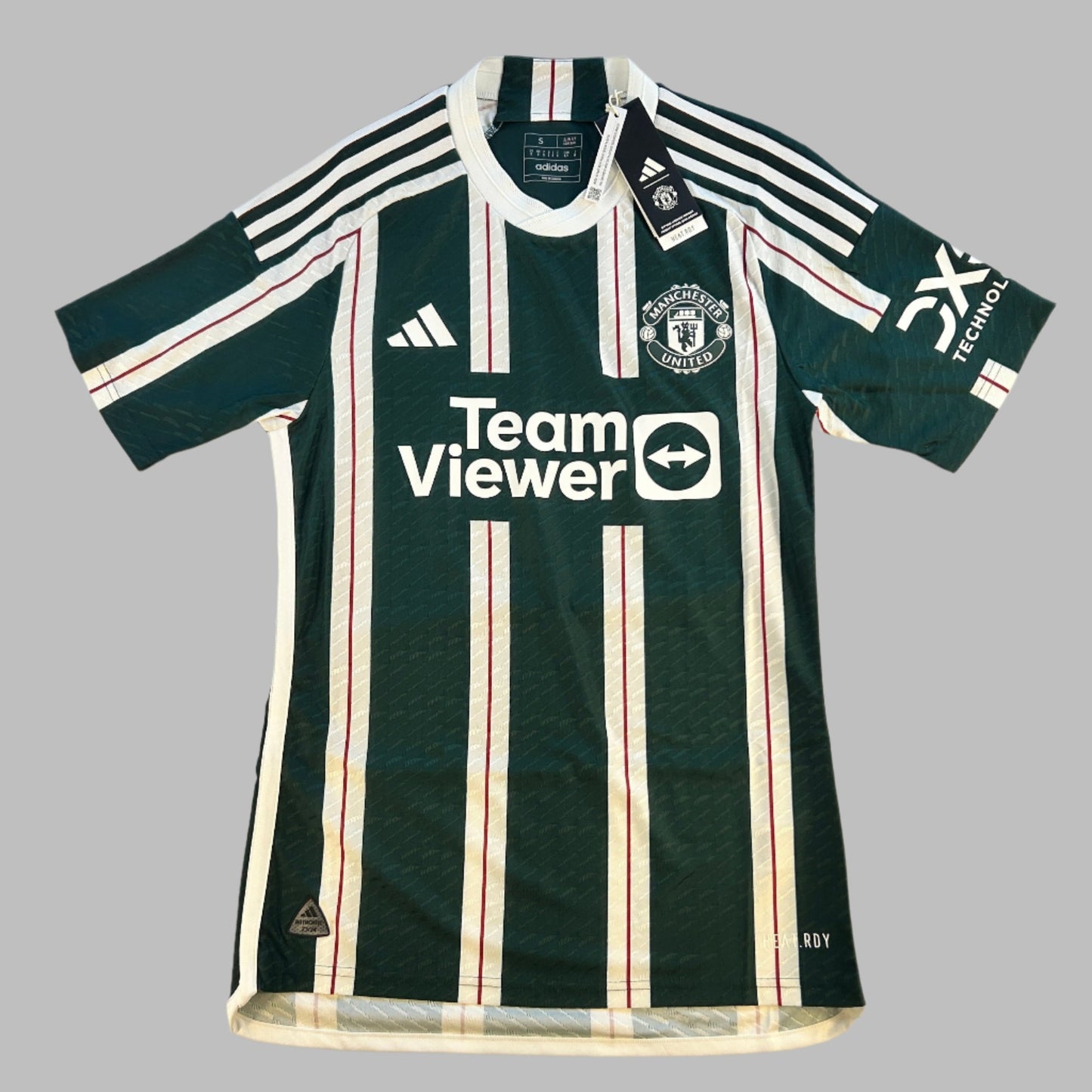 Manchester United 2023-2024 Authentic Away Shirt - Front with Team Viewer sponsor. This is a dark green shirt with think white stripes, in the white stripes there is a thinner red stripe.
