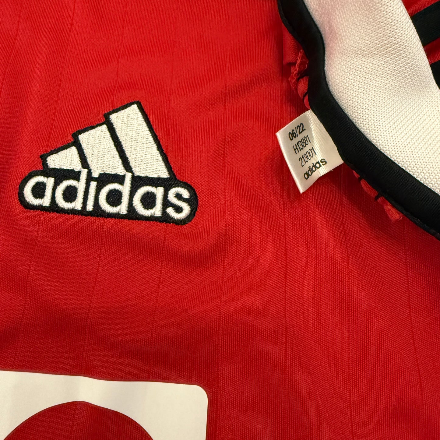 Red Manchester United 2022-2023 Home jersey with logo and Adidas tag code H13881