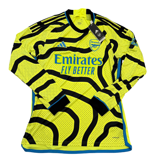 Arsenal away shirt 2023/2024 - Yellow sports jersey with black patterns and branding on a white background