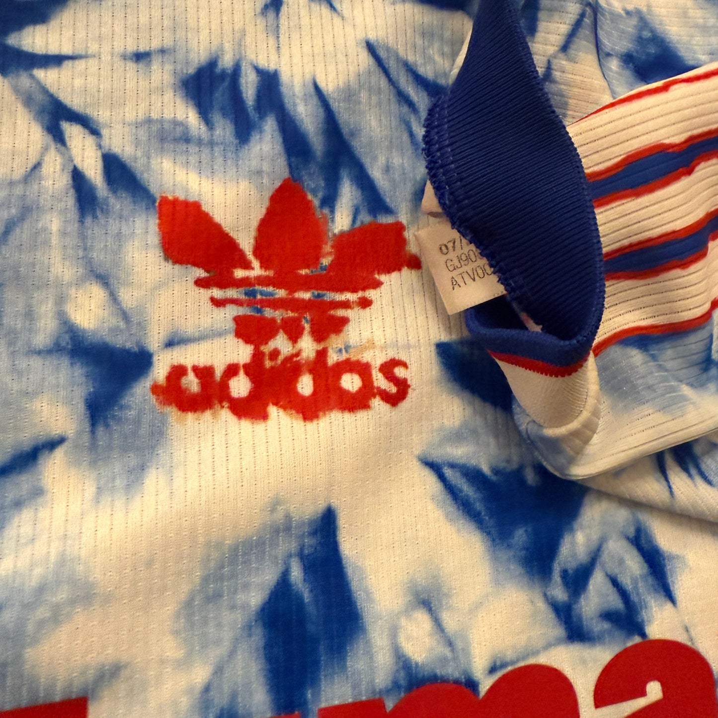 Tie-dye shirt with Adidas logo and branding
