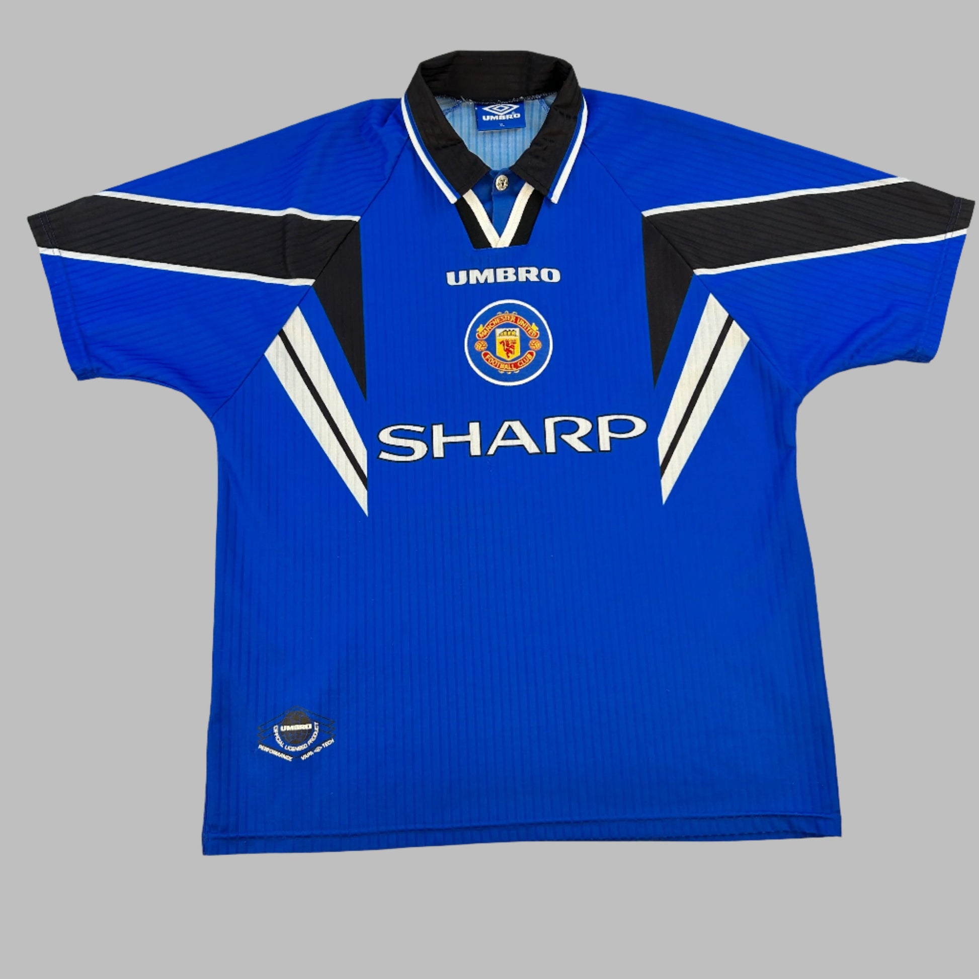 Manchester United 1996-1997-1998 Third Shirt - a blue shirt with central SHARP sponor and Manchester United badge