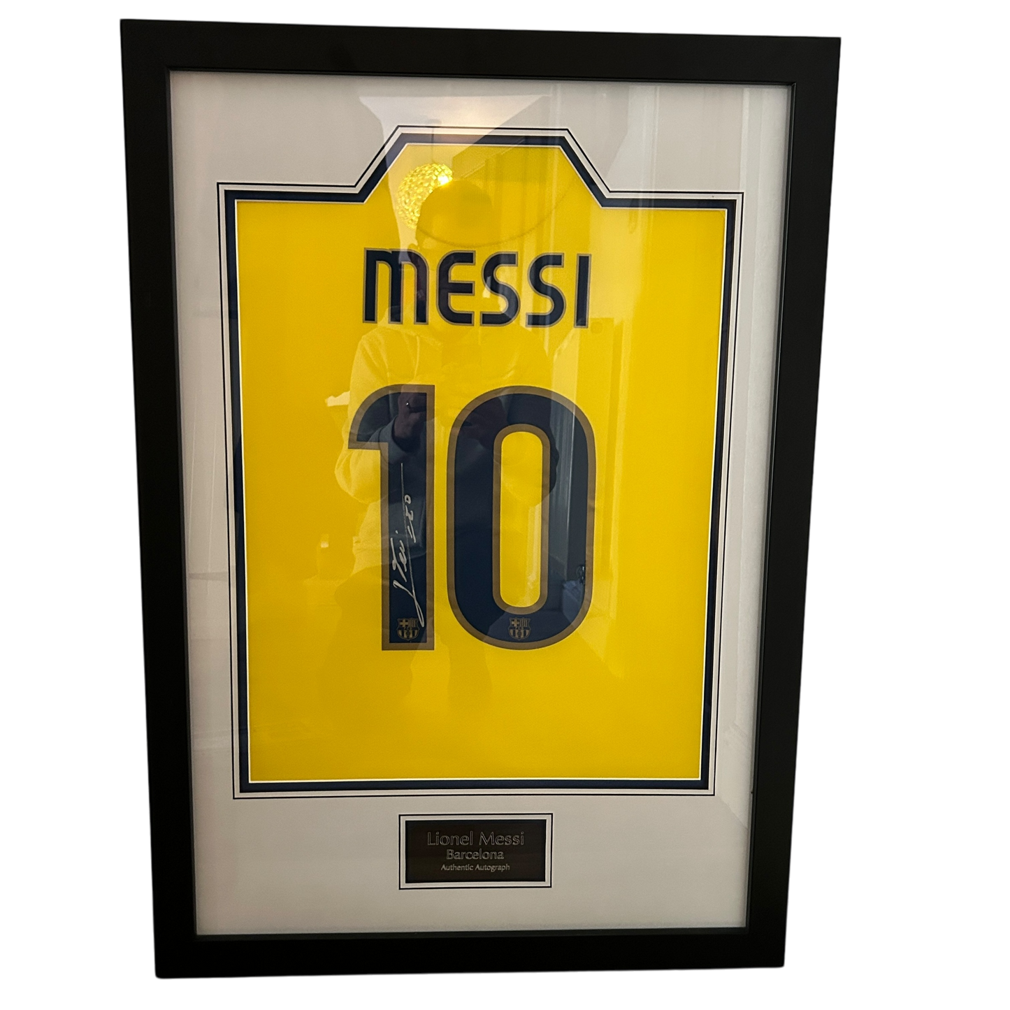 Lionel Messi 2008/2009 Signed Framed Shirt. A yellow away shirt that Leo Messi has signed on the number 1