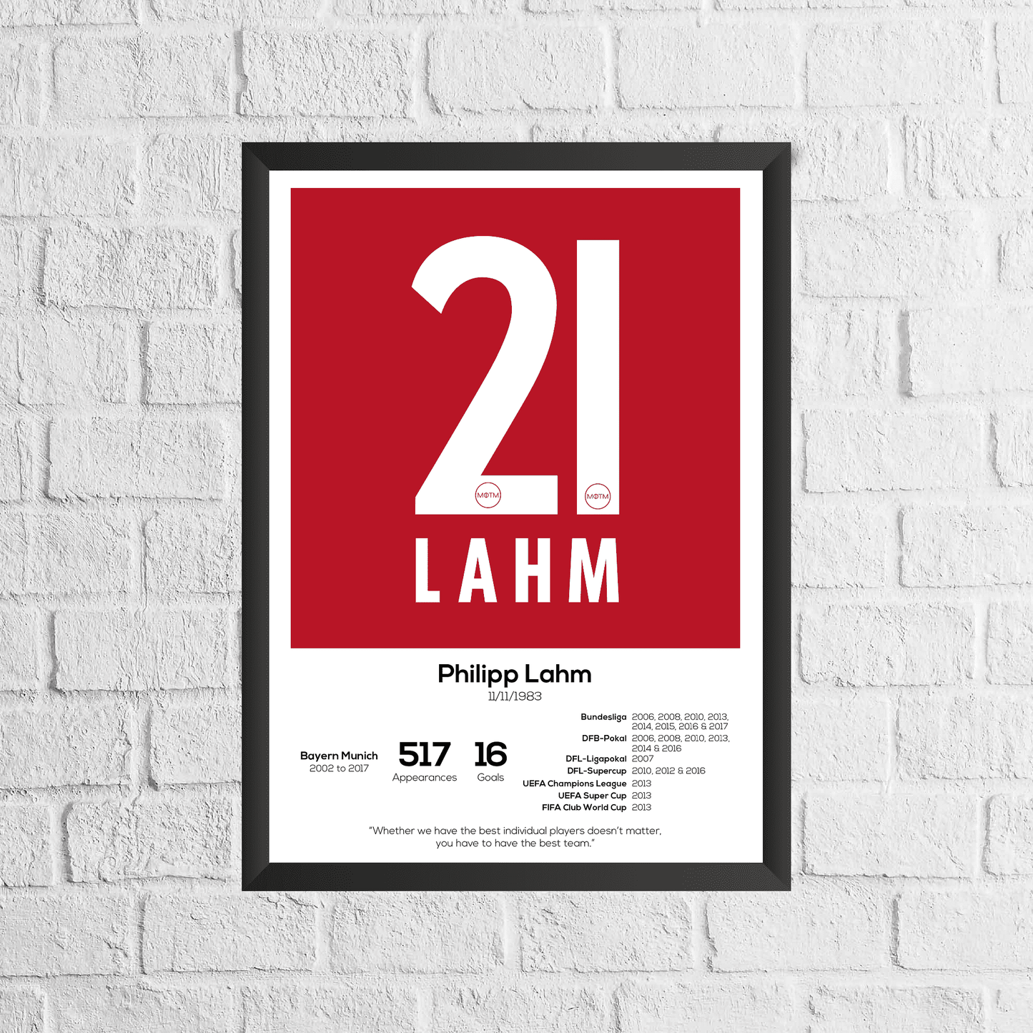 Framed poster with '21 LAHM' on a red background, displayed on a white brick wall.