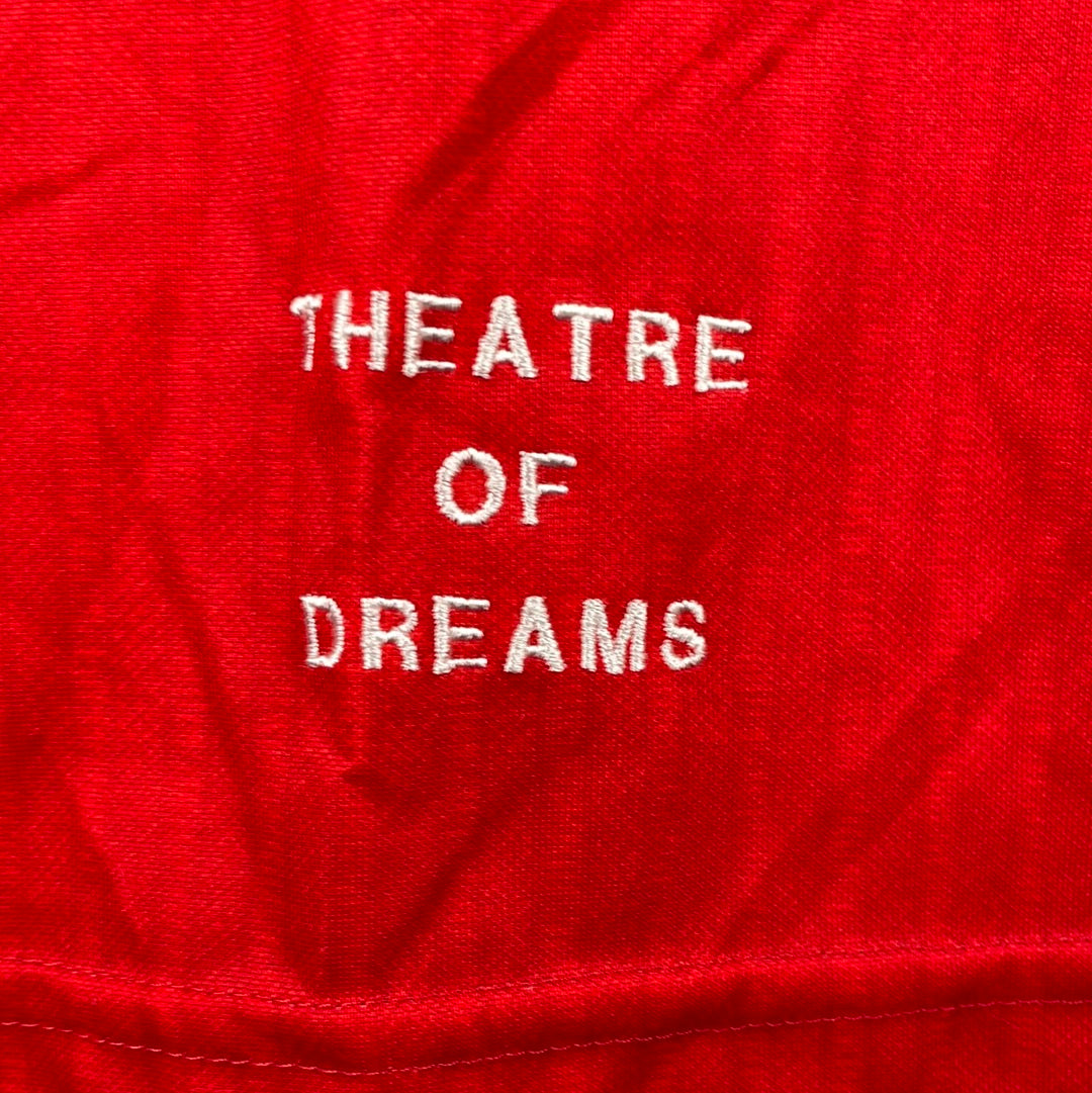 TEATER OF DREAMS is embroidered on the front for a player shirt rather than printed.