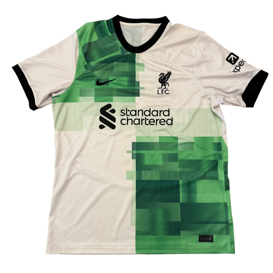Soccer jersey with green and white design, featuring logos and text on a white background - Liverpool 2023/2024 Away Shirt