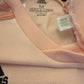 Close-up of a pink Adidas garment with a tag showing the code CG0055.