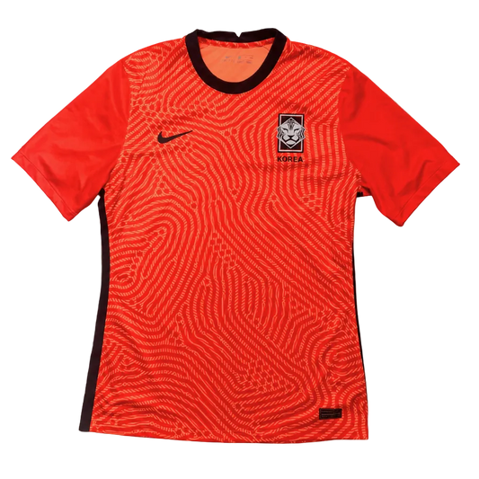 Red Korean football jersey with black accents on a gray background
