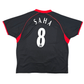 Black sports jersey with red accents and 'Saha 8' printed on the back, on a white background