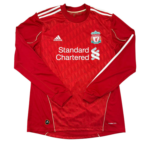 Red sports jersey with Standard Chartered branding on a white background. The Liverpool FC home shirt in the 2010/2011 and 2011/2012 seasons