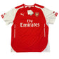 Red and white sports jersey with Emirates logo on a white background. The Arsenal 2014/2015 Home Shirt -