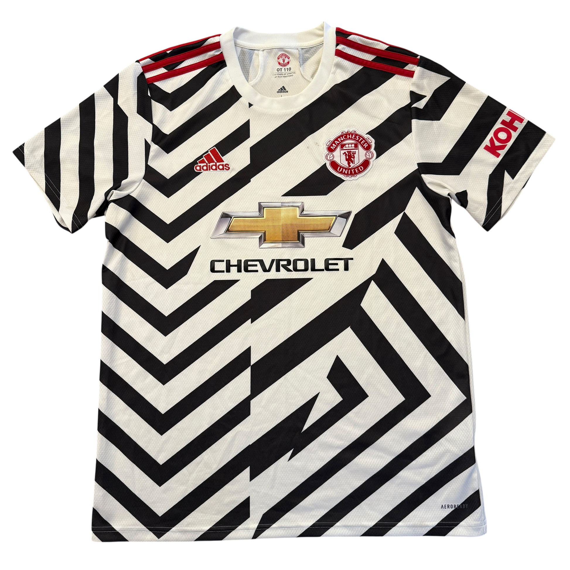 Black and white striped Manchester United 2020-2021 Third jersey with Adidas, Manchester United, and Chevrolet logos on a white background