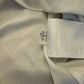 Close-up of a light grey fabric with a brand tag code 835806-106on a matching background