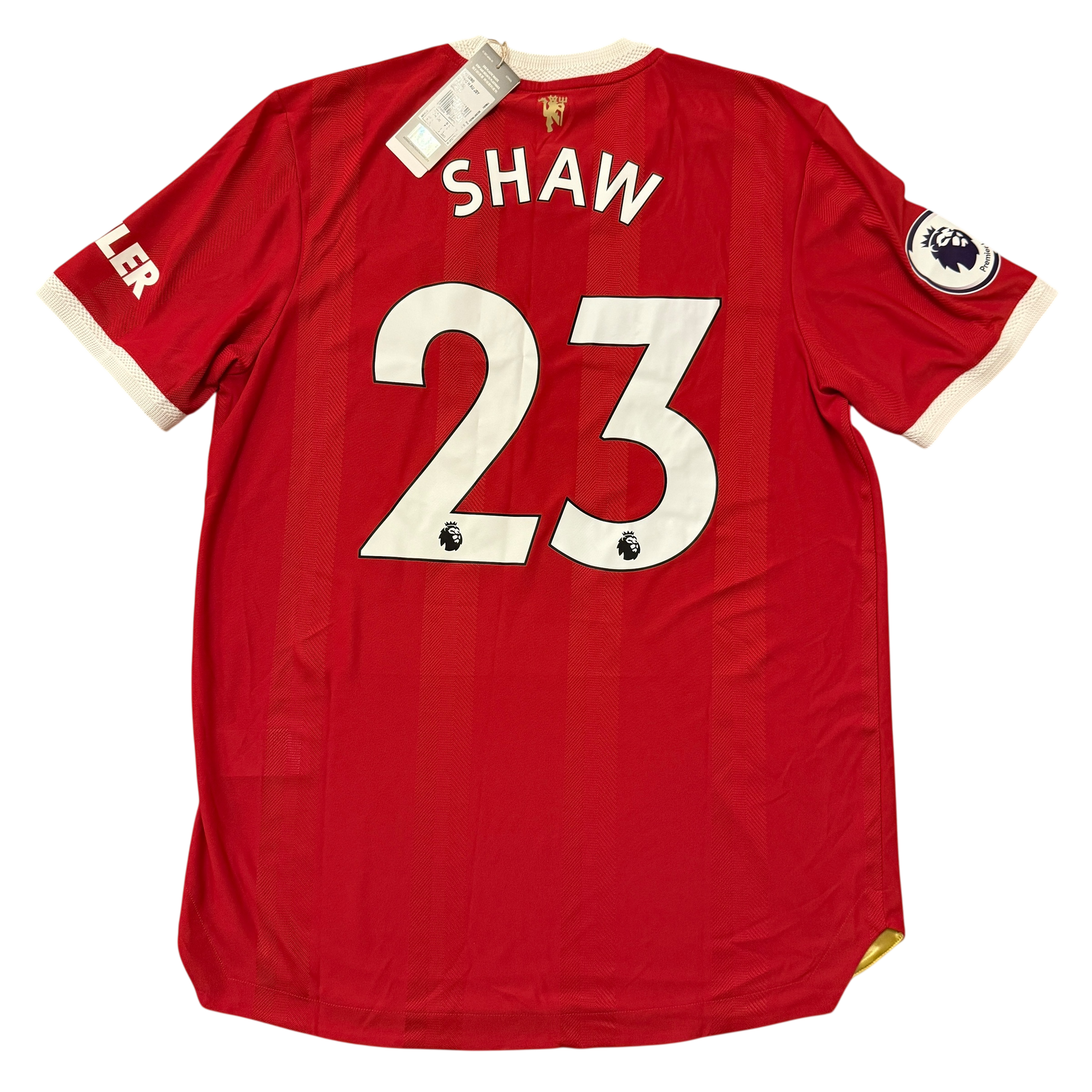 Manchester United 2021-2022 Authentic Home jersey with 'SHAW 23' printed on the back, on a white background