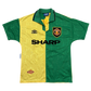 Green and yellow sports jersey with Manchester United logo and Umbro branding on a white background - The Manchester United 1992/1993/1994 Third Shirt