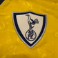 Emblem with a bird design on a yellow background - The Spurs badge in 1994
