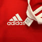 Red Adidas sports jersey with brand logo and tag.Code H31447 correct for the Manchester United 2021-2022 Home Shirt 