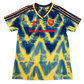 Tie-dye Arsenal jersey with 'Humanrace' text on a white background