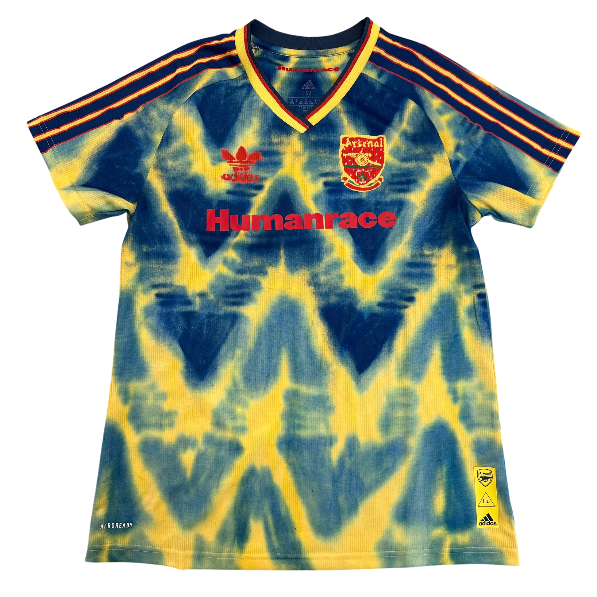 Tie-dye Arsenal jersey with 'Humanrace' text on a white background