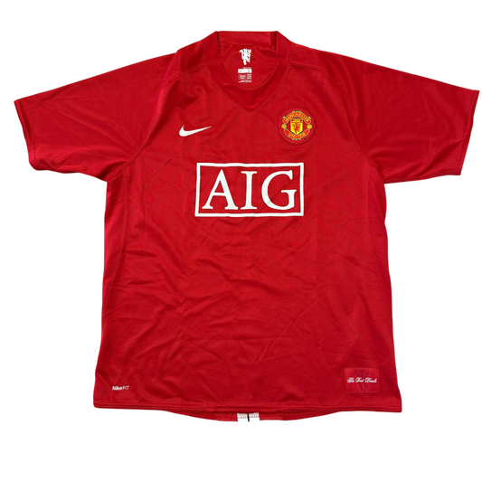 Red Manchester United 2007/2008 Home jersey with AIG logo and Manchester United emblem on a white background