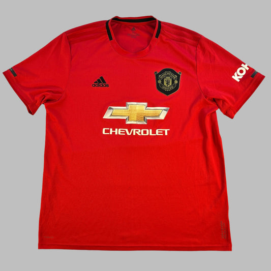 Manchester United 2019/2020 Home Shirt - A red shirt with black crest around the badge