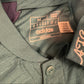 Close-up of an Adidas jacket with brand label showing code HZ2121 and logo.
