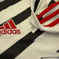 Close-up of Adidas logo on a sports jersey with a tag FM4263.