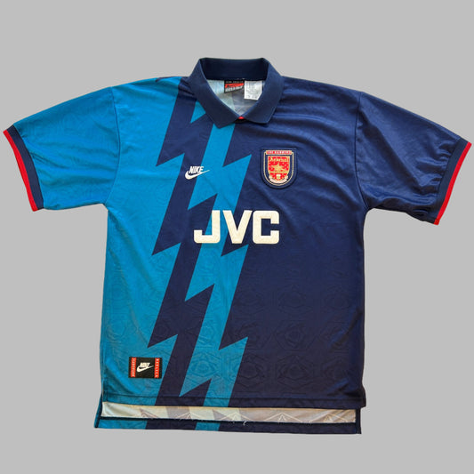 Arsenal 1994/1995 Away Shirt, a dark blue shirt with light blue lightening design. An iconic vintage Arsenal shirt