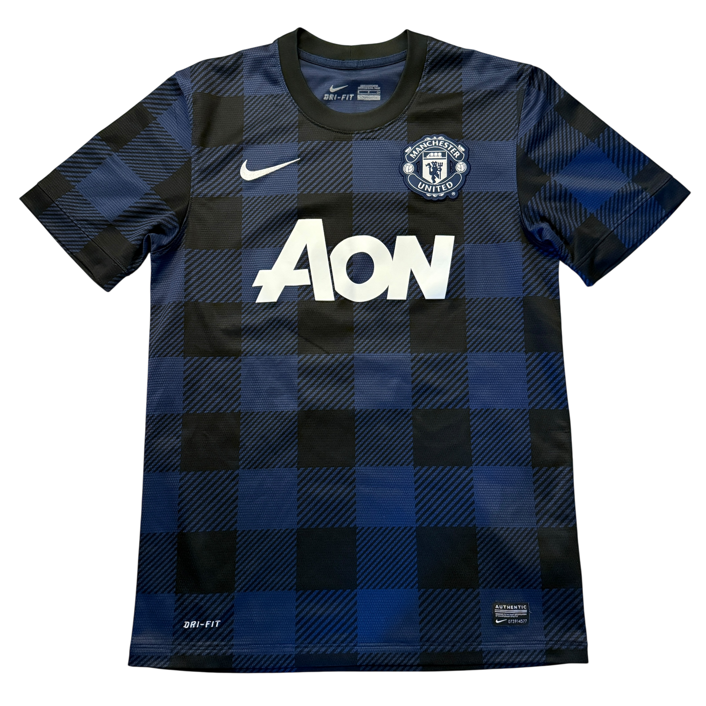 Checkered blue and black Manchester United 2013/14 Away jersey with AON branding in white on a white background