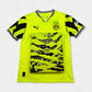 Bright yellow Borussia Dortmund 2024-25 Anniversary Edition jersey with black patterns and branding on a white background