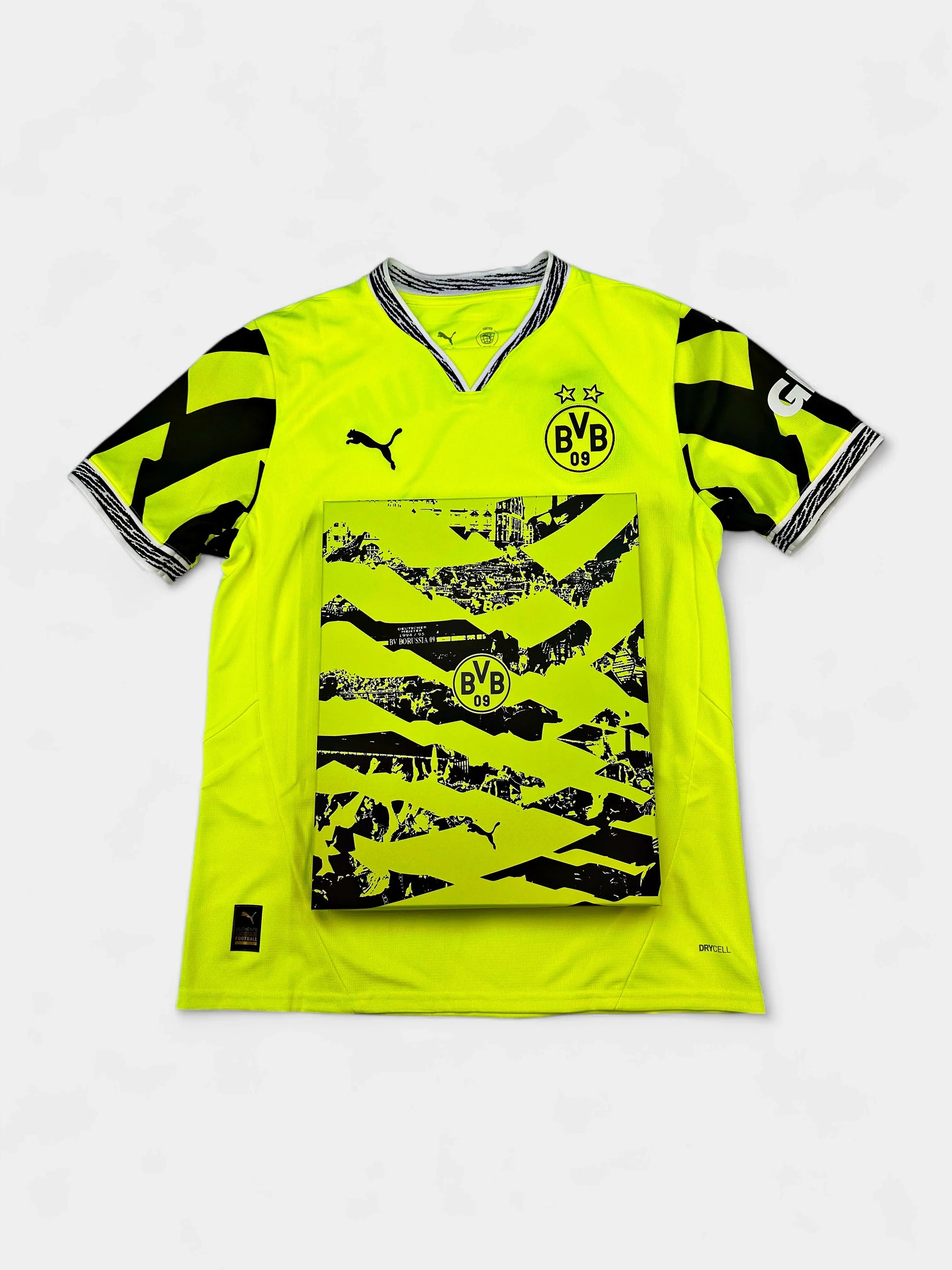 Bright yellow Borussia Dortmund 2024-25 Anniversary Edition jersey with black patterns and branding on a white background