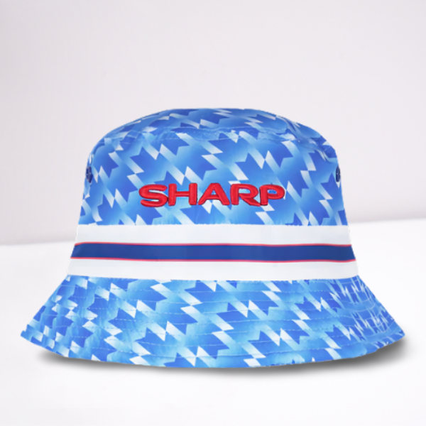 Blue bucket hat with geometric pattern and 'SHARP' text in red. The design is based on the Manchester United 1990 away shirt. 