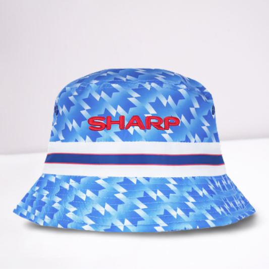 Blue bucket hat with geometric pattern and 'SHARP' text in red. The design is based on the Manchester United 1990 away shirt. 