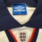 Close-up of a sports jersey with Umbro label and England emblem