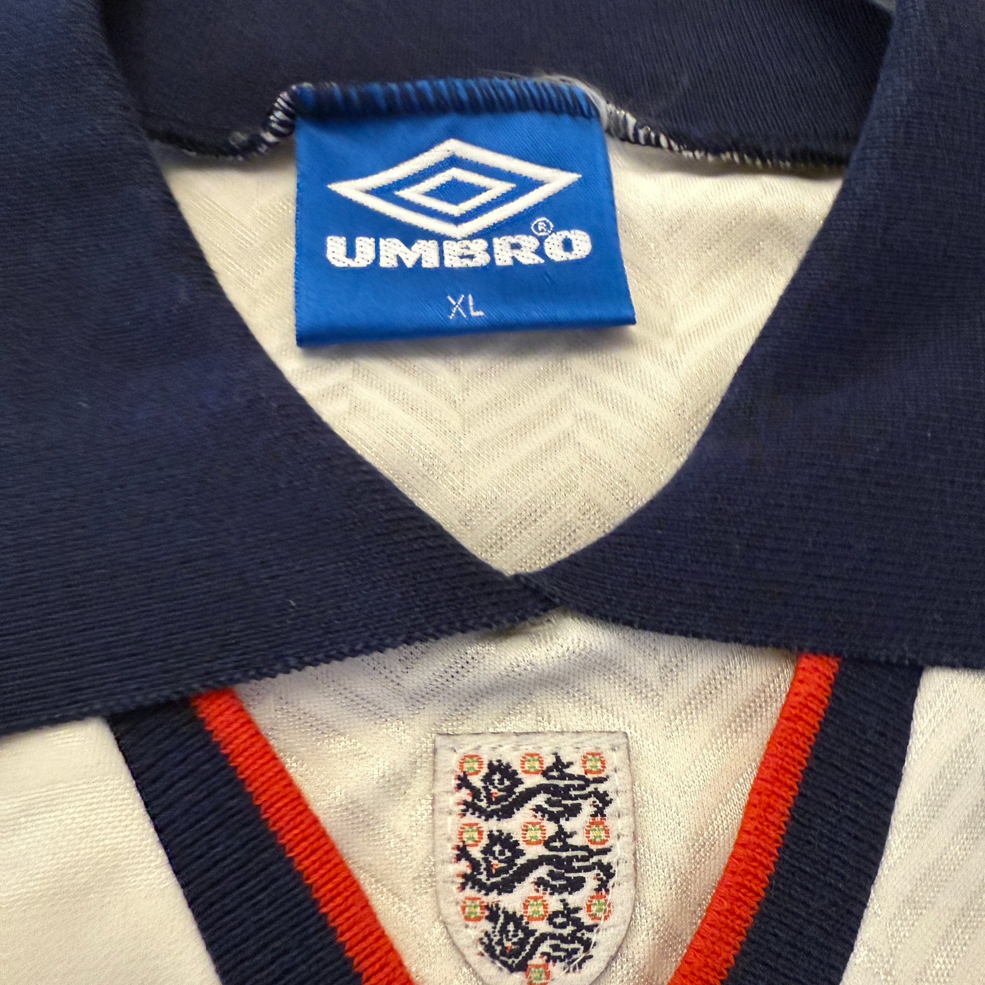 Close-up of a sports jersey with Umbro label and England emblem
