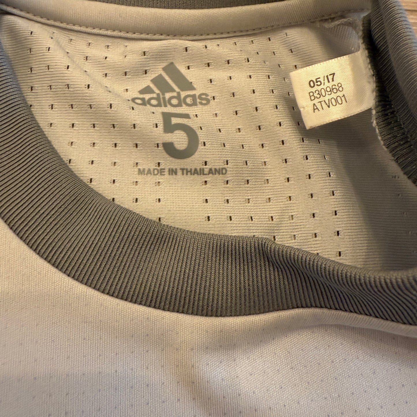 Close-up of Adidas sports jersey with brand logo and text. Adidas code B30968 for the player version of this shirt