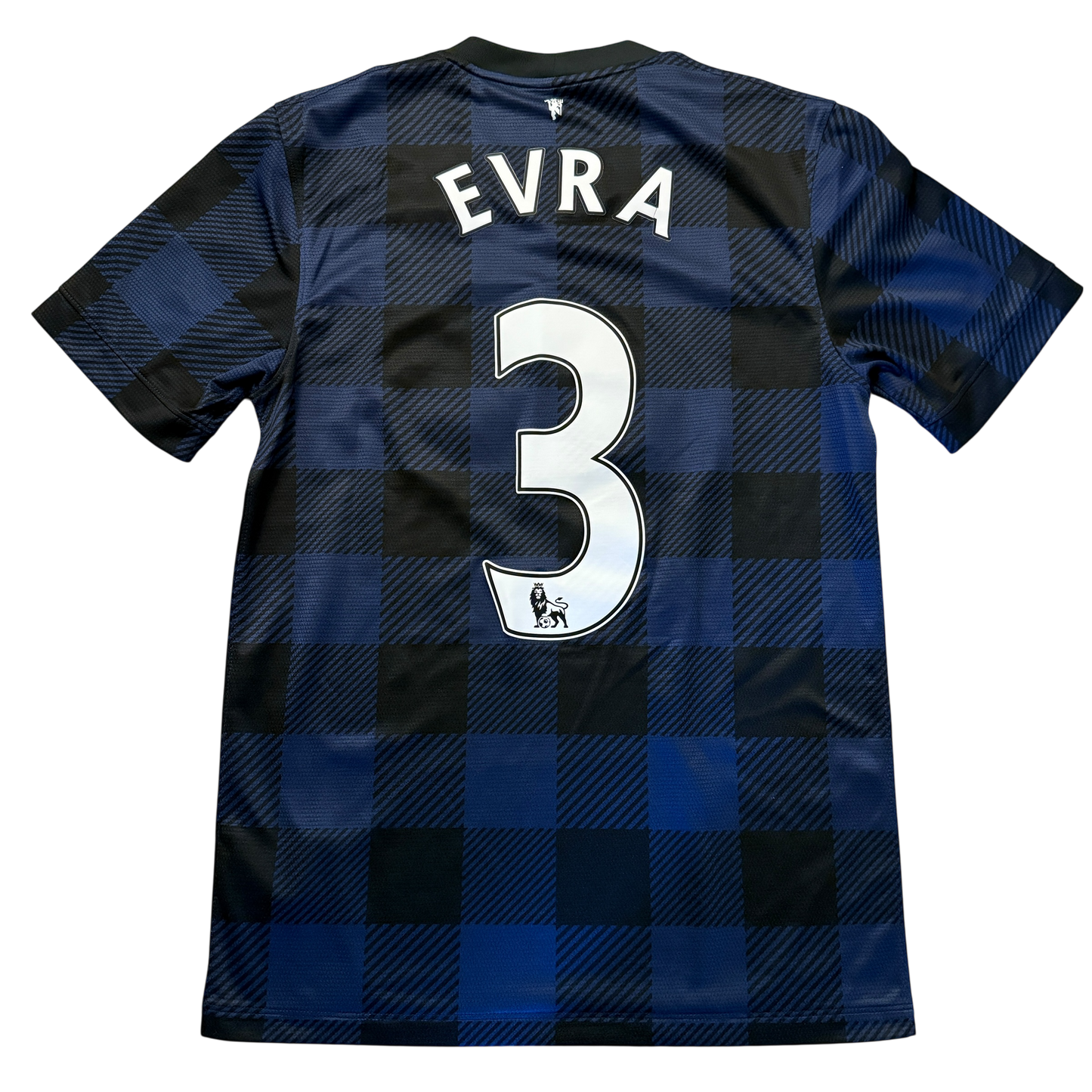 Blue and black checkered Manchester United 2013/14 Away jersey with 'EVRA' and number '3' on a white background