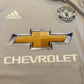 Close-up of a sports jersey with Chevrolet, Adidas, and Manchester United logos.