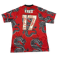 Red sports jersey with black dragon patterns and 'FRED' branding on a white background