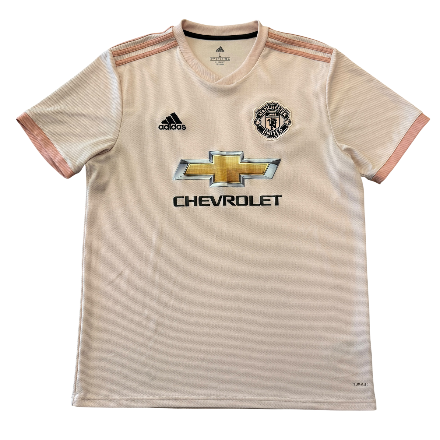Pink Manchester United 2018/2019 Away jersey with Adidas and Chevrolet logos on a white background
