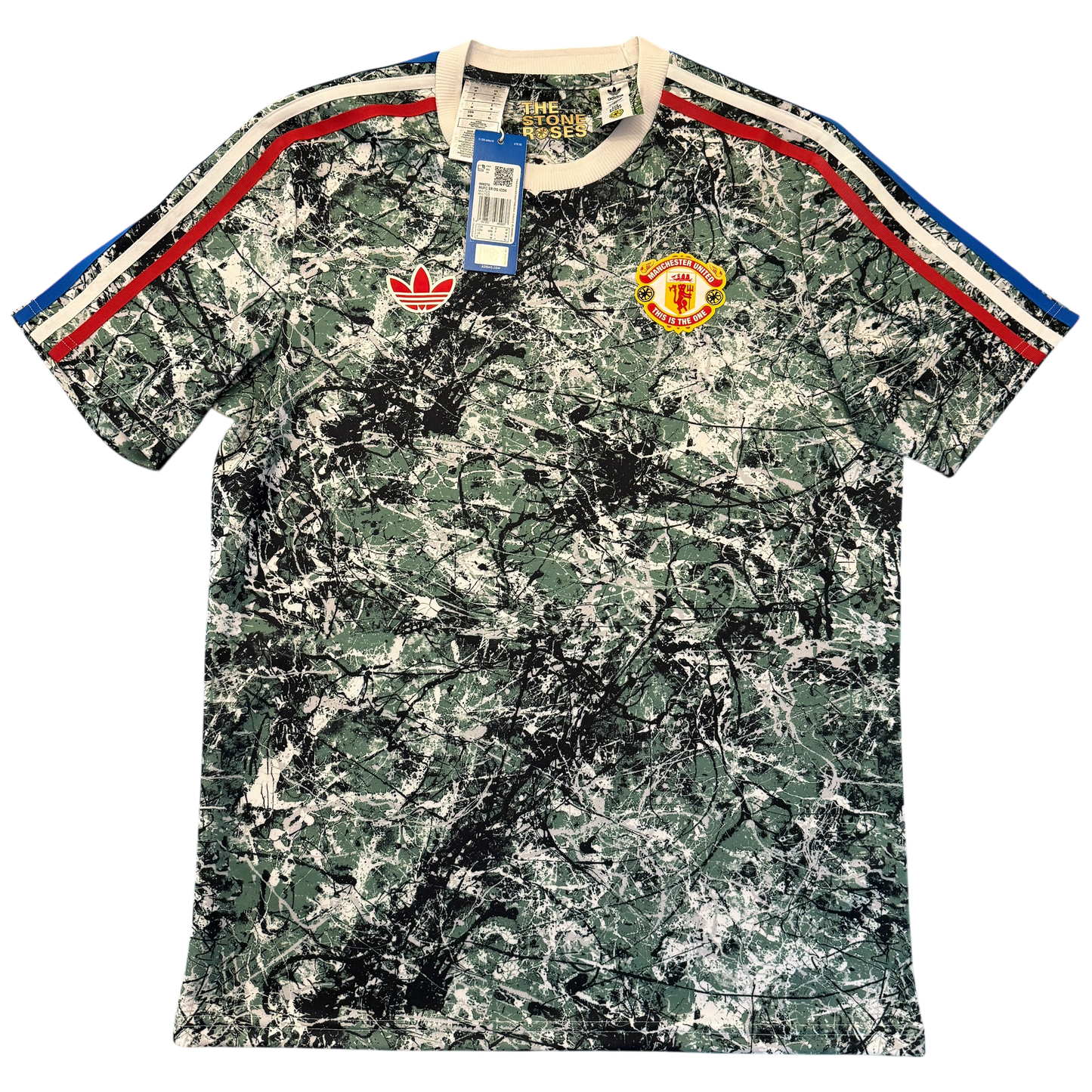 Camouflage-patterned Manchester United Stone Roses Icons Shirt with brand logos on a white background