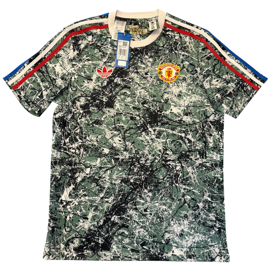 Camouflage-patterned Manchester United Stone Roses Icons Shirt with brand logos on a white background