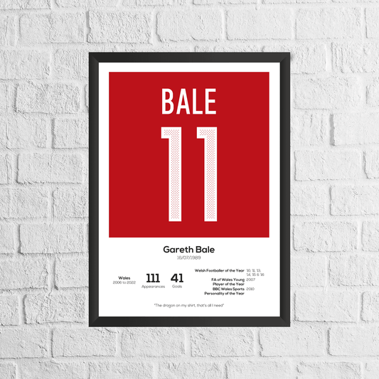 Framed poster with 'BALE 11' on a red background, displayed on a white brick wall.
