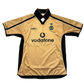 Gold side of the Manchester United 2001-2002 Third jersey with black accents and Vodafone logo on a white background