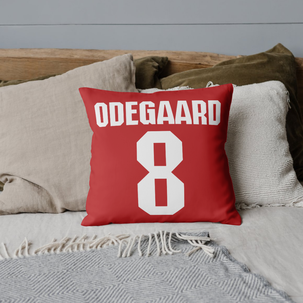 Odegaard 8 Arsenal Font Style Cushion Cover on a bed with other cushions