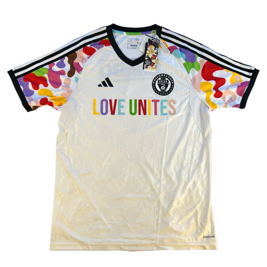 White sports jersey with colorful sleeves and 'LOVE UNITES' text, featuring Adidas logo. Philiadelphia_Union_20222023_Love_Unites_Shirt_front