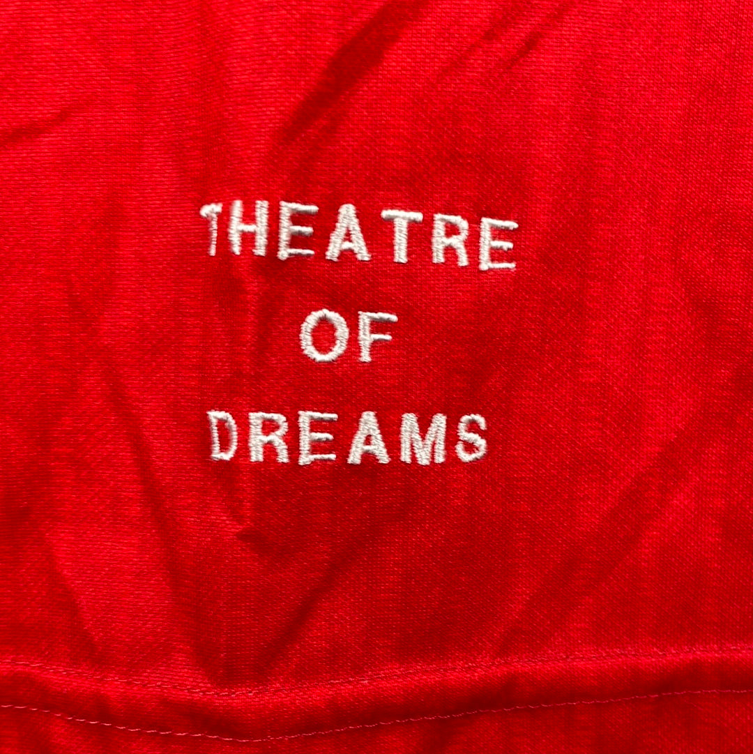 TEATER OF DREAMS is embroidered on the front for a player shirt rather than printed. 